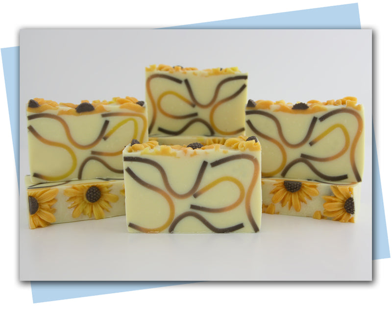 brown/orange/yellow ombre waves in a yellow base soap with sunflowers on top