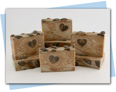 Gold and white swirled bars of soap with heart embed