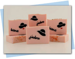 pink soap with a classy hat embeds and a stamp that says j'adore bars of soap