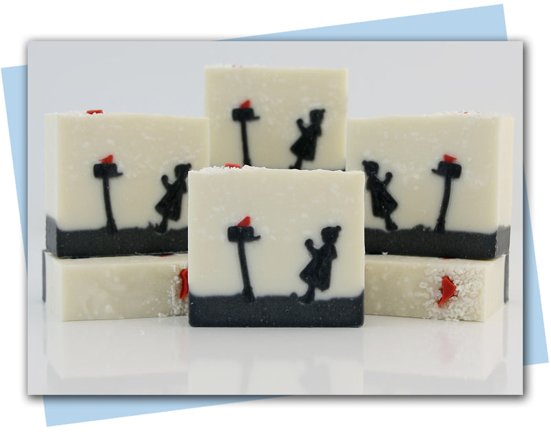 Bars of soap with a girl putting a present in a mail box ad a red bird sitting on mailbox
