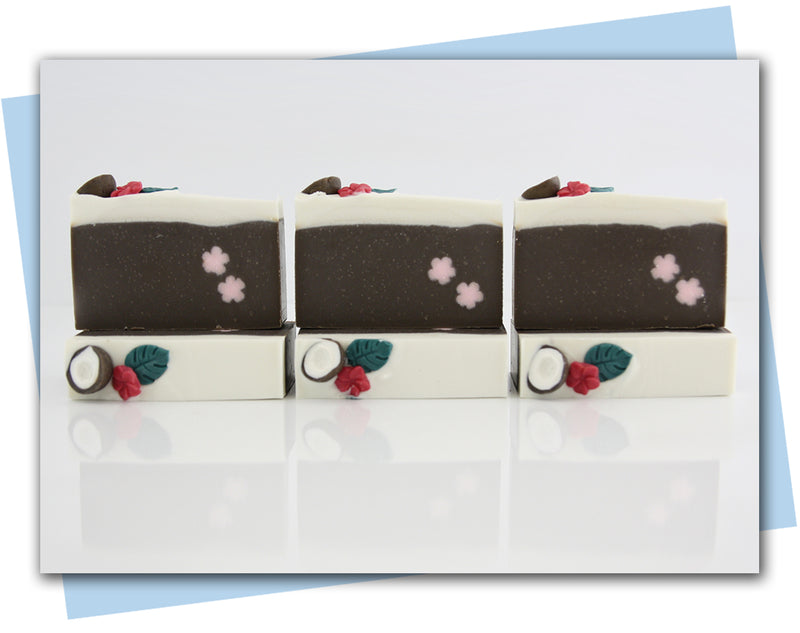 coconut themed soap with coconut and tropical flower embed on top and pink flower embed in the bar