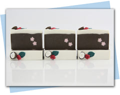 coconut themed soap with coconut and tropical flower embed on top and pink flower embed in the bar