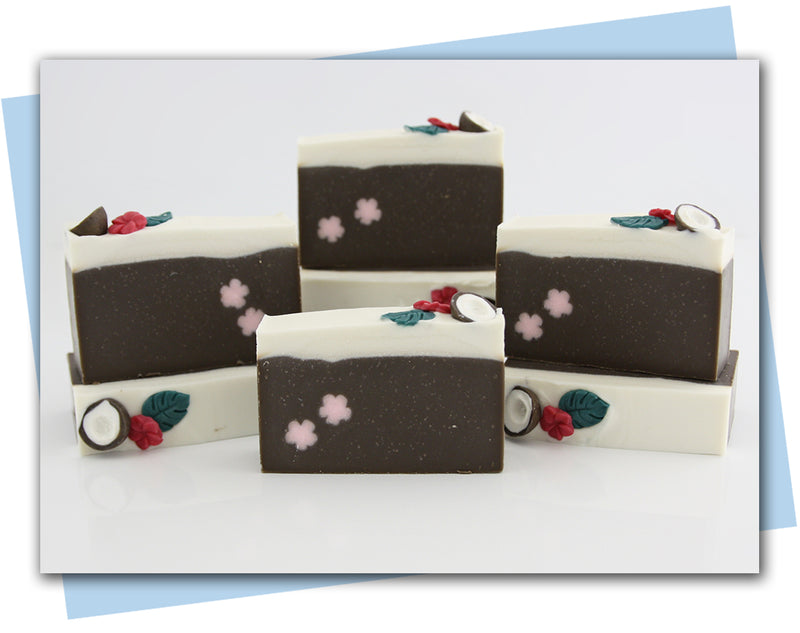 coconut themed soap with coconut and tropical flower embed on top and pink flower embed in the bar