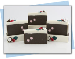 coconut themed soap with coconut and tropical flower embed on top and pink flower embed in the bar