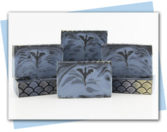 bars of soap with a dragon embed and blue and black swirls and scales on top
