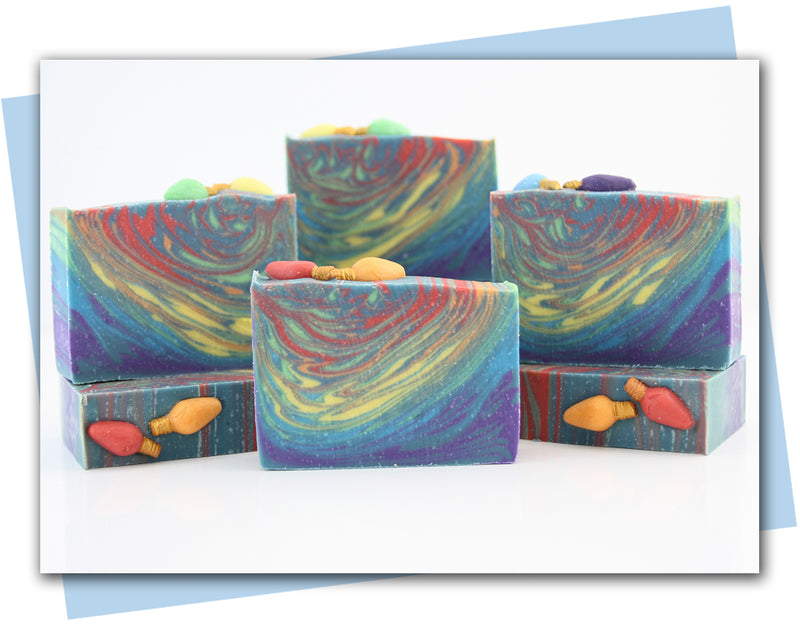 Abstract christmas tree deign with rain bow swirls and Christmas lights on top.