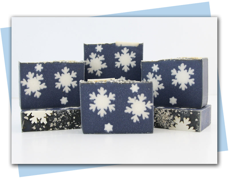 dark blue sky with white snowflakes in bar bars of soap