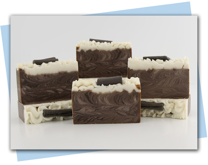 Bars of soap with brown swirl and frosting top with cinnamon stick