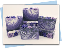 purples and whites in swirl design with purple flowers on the top - bars of soap