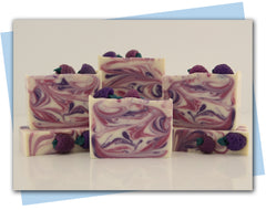 three shades of purple and white swirled bar with mulberry embeds on top