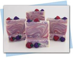 bars of soap with pink and purple swirls and berries on top