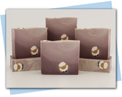 bars of soap with a dark plum to light plum ombre with a little sheep embed