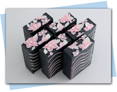 Soap with black base and pink and white waves and flowers on top