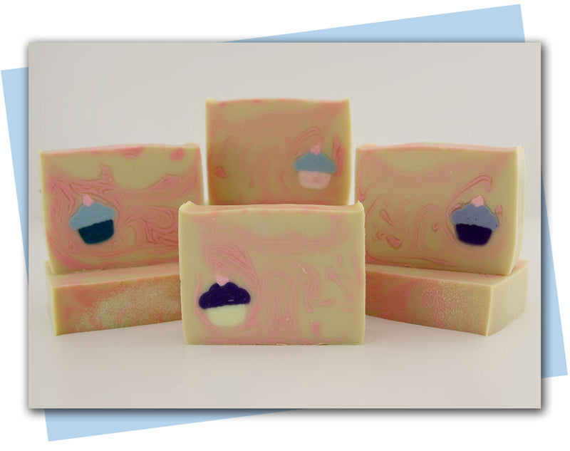 yellow bar of soap with pink swirls and a cupcake imbed in the bar