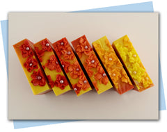 Ombre bars of soap from red to yellow ombre with flowers on top 