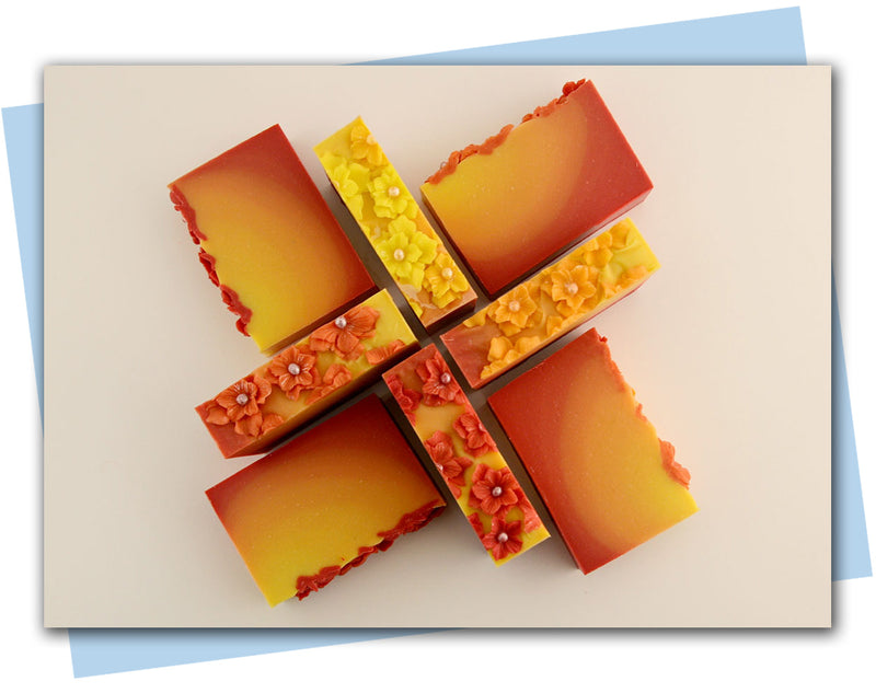 Ombre bars of soap from red to yellow ombre with flowers on top 