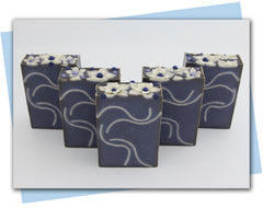 blue base soap with white swirls and white flowers on top
