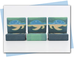 Green ombre bar of soap with turtle outline that is infilled with an ocean scene
