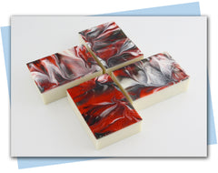 white bar of soap with red/black/white swirl dipped top